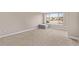 Bright bedroom featuring neutral walls, soft carpet, a window, and a comfy ottoman at 8802 E 148Th Ln, Thornton, CO 80602