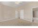 This neutral bedroom includes two doorways and ceiling fan at 8802 E 148Th Ln, Thornton, CO 80602