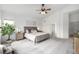 Bright and airy bedroom featuring plush carpeting, a ceiling fan, and ensuite bath at 8802 E 148Th Ln, Thornton, CO 80602