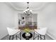 Stylish dining space with modern chairs, chandelier, and view into an open concept living area at 8802 E 148Th Ln, Thornton, CO 80602