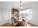 Cozy dining area with hardwood floors and large windows that provides plenty of natural light at 8802 E 148Th Ln, Thornton, CO 80602