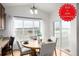 Bright dining area features a round table with seating, large windows and sliding glass door with views at 8802 E 148Th Ln, Thornton, CO 80602