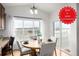 Bright dining area featuring a round wooden table, scenic views, and modern lighting fixtures at 8802 E 148Th Ln, Thornton, CO 80602