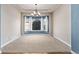 Elegant dining room featuring a bay window, a modern chandelier, and neutral decor for a sophisticated ambiance at 8802 E 148Th Ln, Thornton, CO 80602