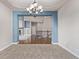 Elegant dining room showcasing a chandelier and access to both the living room and main stairway to the upper level at 8802 E 148Th Ln, Thornton, CO 80602