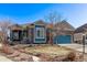 Charming home showcasing a blue exterior, a well-maintained yard, and mature landscaping at 8802 E 148Th Ln, Thornton, CO 80602