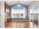 Bright kitchen area with wooden cabinetry, countertops, modern appliances, and ample natural light through a large window at 8802 E 148Th Ln, Thornton, CO 80602