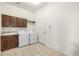 Laundry room with white appliances and cabinets at 8802 E 148Th Ln, Thornton, CO 80602