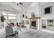 Spacious living room with vaulted ceiling, fireplace, built-ins, and comfortable seating area at 8802 E 148Th Ln, Thornton, CO 80602
