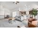 Open-concept home featuring living room with fireplace and spacious kitchen with breakfast bar at 8802 E 148Th Ln, Thornton, CO 80602