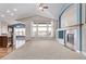 Inviting living room featuring vaulted ceilings, large windows, a ceiling fan, and a fireplace at 8802 E 148Th Ln, Thornton, CO 80602