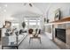 Cozy living room showcasing fireplace, built-ins, and view of kitchen at 8802 E 148Th Ln, Thornton, CO 80602