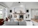 Bright living room featuring built-in shelving, a cozy fireplace, and neutral decor at 8802 E 148Th Ln, Thornton, CO 80602