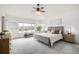 Spacious main bedroom features a ceiling fan, large windows, and scenic neighborhood views at 8802 E 148Th Ln, Thornton, CO 80602