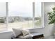 Scenic view from the interior featuring neighborhood homes and tree-lined streets visible through a large window at 8802 E 148Th Ln, Thornton, CO 80602