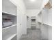 Organized walk-in closet with shelving, rods, and space, offering organized storage solutions at 8802 E 148Th Ln, Thornton, CO 80602