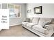 Main floor office featuring a comfortable sofa, neutral carpet, and a window for natural light at 22441 E Chenango Dr, Aurora, CO 80015