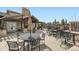 Outdoor patio featuring comfortable seating, stone fireplace, and scenic community views at 22441 E Chenango Dr, Aurora, CO 80015