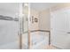Modern bathroom with a bathtub and glass shower door at 8551 Gold Peak Dr # B, Highlands Ranch, CO 80130