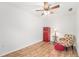 Charming bedroom with wood floors, red refrigerator, and comfy armchair at 8551 Gold Peak Dr # B, Highlands Ranch, CO 80130