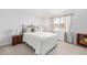 Comfortable bedroom with a bed, nightstand and window curtains at 8551 Gold Peak Dr # B, Highlands Ranch, CO 80130