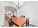 Bright dining room with hardwood floors and view into kitchen at 8551 Gold Peak Dr # B, Highlands Ranch, CO 80130