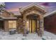 Snow covered front entrance of charming townhome with stone accents at 8551 Gold Peak Dr # B, Highlands Ranch, CO 80130
