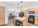 Kitchen with light wood cabinets, granite countertops, and black appliances at 8551 Gold Peak Dr # B, Highlands Ranch, CO 80130