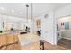 Open kitchen features island, breakfast bar, and laundry access at 8551 Gold Peak Dr # B, Highlands Ranch, CO 80130
