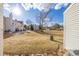 Spacious backyard featuring a large grassy area, landscaping, and glimpses of surrounding homes at 3281 S Estes St, Lakewood, CO 80227