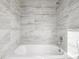 Bathroom features a bathtub with tiled walls and a shower head at 3281 S Estes St, Lakewood, CO 80227