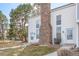 Charming townhouse with white siding, a brick chimney, and a well-maintained front lawn at 3281 S Estes St, Lakewood, CO 80227