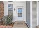 Inviting front entry featuring a glass-paneled door, modern house numbers, and neatly trimmed shrubs at 3281 S Estes St, Lakewood, CO 80227