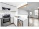 View of the kitchen, featuring stainless steel appliances and modern white cabinets and marble countertops at 3281 S Estes St, Lakewood, CO 80227