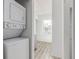 Laundry room includes a stackable washer and dryer, with views into a bright, neutral room at 3281 S Estes St, Lakewood, CO 80227