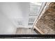An overhead view of the sunlit living room, boasting a stone wall and three windows at 3281 S Estes St, Lakewood, CO 80227