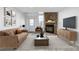 Bright living room with stone fireplace, modern furniture, and new floors, perfect for relaxing and entertaining at 3281 S Estes St, Lakewood, CO 80227