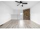 View of the loft area featuring a modern ceiling fan and a stone wall at 3281 S Estes St, Lakewood, CO 80227