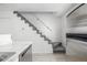 Carpeted staircase next to kitchen featuring stainless steel refrigerator at 3281 S Estes St, Lakewood, CO 80227