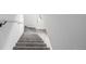 View of the carpeted staircase with metal handrail leading up to the second floor at 3281 S Estes St, Lakewood, CO 80227