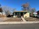 Charming single-story home with a covered front porch and low-maintenance landscaping at 7870 Magnolia St, Commerce City, CO 80022