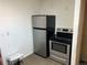 Stainless steel refrigerator and range appliances in this efficient kitchen space at 7870 Magnolia St, Commerce City, CO 80022