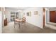 Bright dining room with a classic chandelier, sliding glass doors, and access to hallway at 12087 W New Mexico Ave, Lakewood, CO 80228