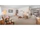 Comfortable living room featuring neutral colors, classic furnishings, and a view into the dining area at 12087 W New Mexico Ave, Lakewood, CO 80228