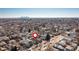Aerial view of a neighborhood showcasing tree-lined streets and the city skyline in the distance at 4166 N Yates St, Denver, CO 80212