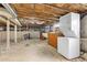 Unfinished basement area featuring laundry hookups and exposed ceiling at 4166 N Yates St, Denver, CO 80212