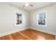 Bright bedroom with hardwood floors, white walls, and two windows for natural light at 4166 N Yates St, Denver, CO 80212