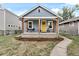 Attractive home exterior with a welcoming front porch and well-maintained landscaping at 4166 N Yates St, Denver, CO 80212