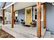 Charming front porch with sturdy wood columns and a cheerful yellow front door at 4166 N Yates St, Denver, CO 80212