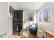 A bright, sunny laundry room features a modern washer and dryer and natural wood flooring at 4166 N Yates St, Denver, CO 80212